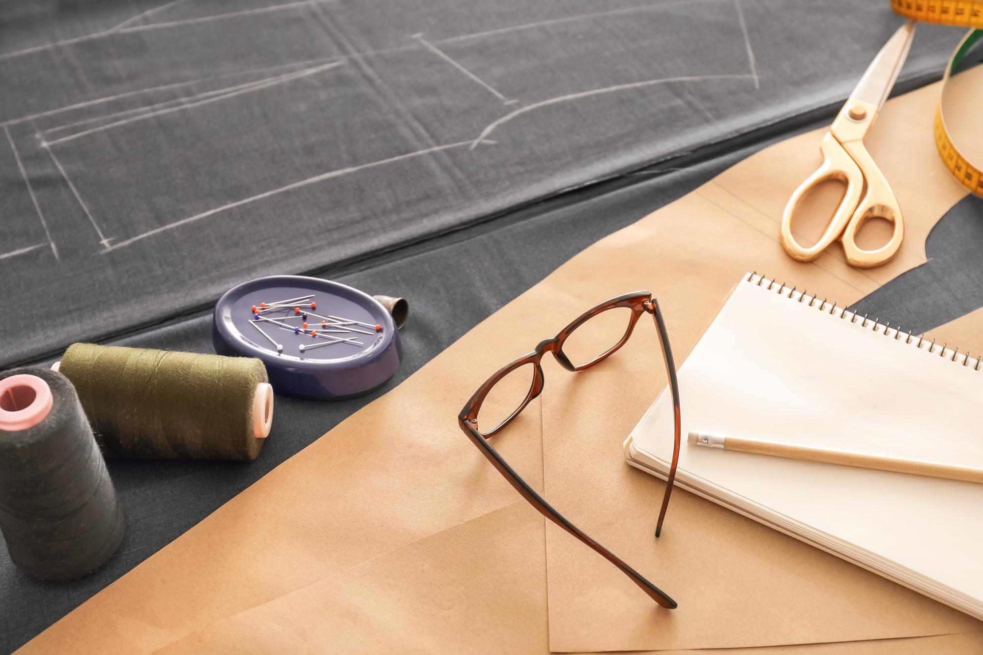 Designer drafting embroidery vector over fabric sample